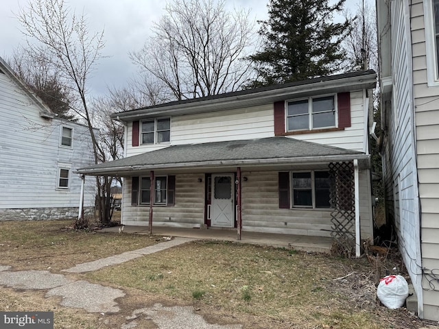 view of front of property with a shingled roof and covered porch