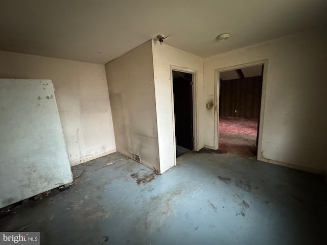 empty room featuring concrete flooring and visible vents