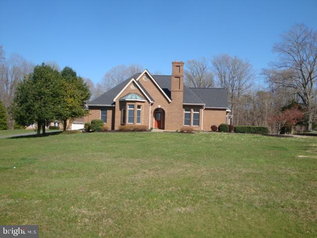 view of front of property with a chimney and a front yard