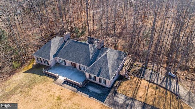 drone / aerial view featuring a view of trees