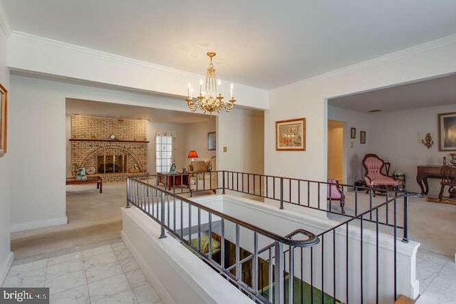 hall featuring light carpet, baseboards, ornamental molding, an upstairs landing, and a chandelier