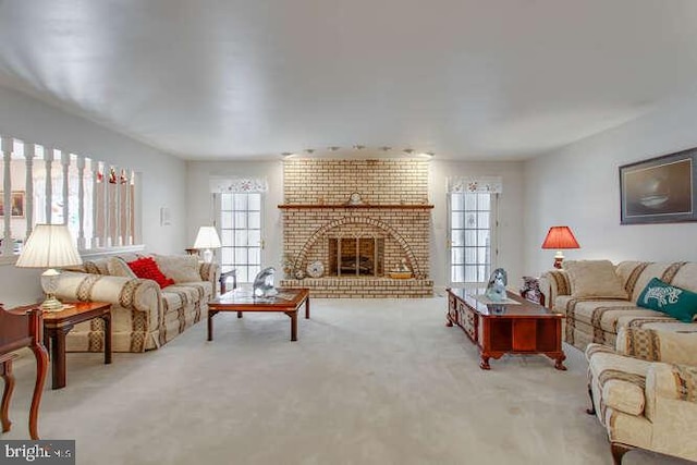 carpeted living area featuring a brick fireplace