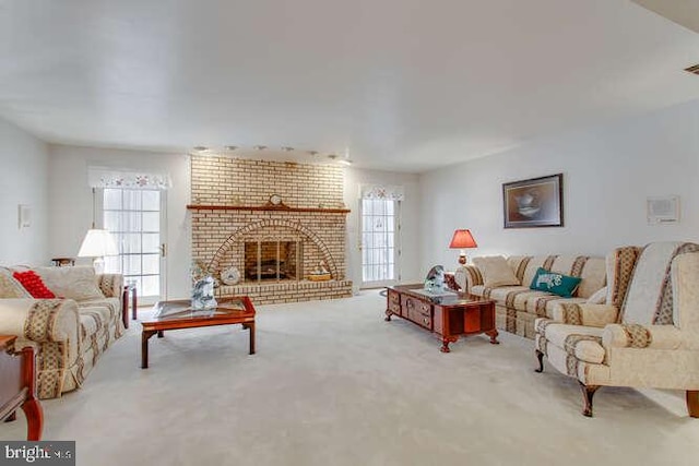 carpeted living room with a brick fireplace and visible vents