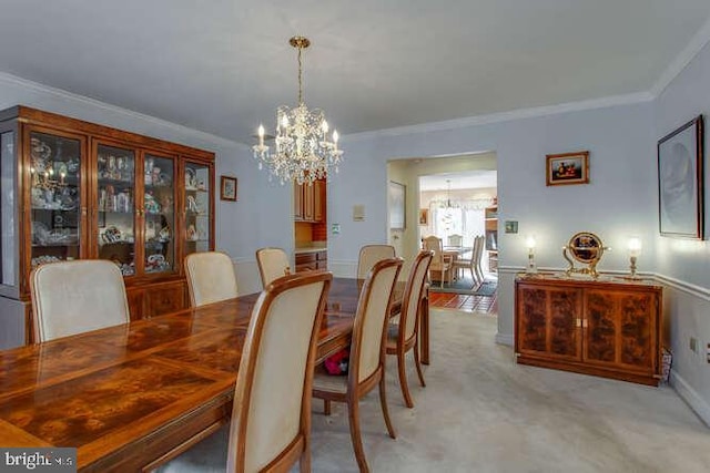 dining area featuring a chandelier, light carpet, and crown molding