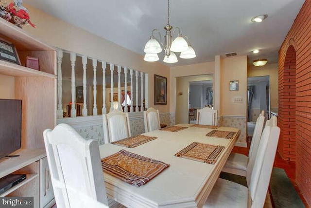 dining room featuring visible vents and a chandelier