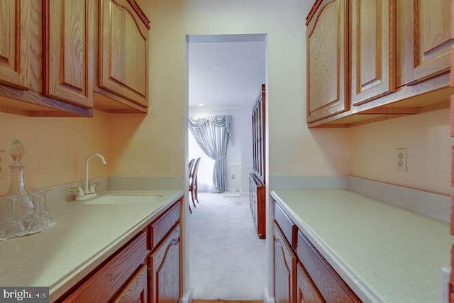 kitchen with light countertops and a sink