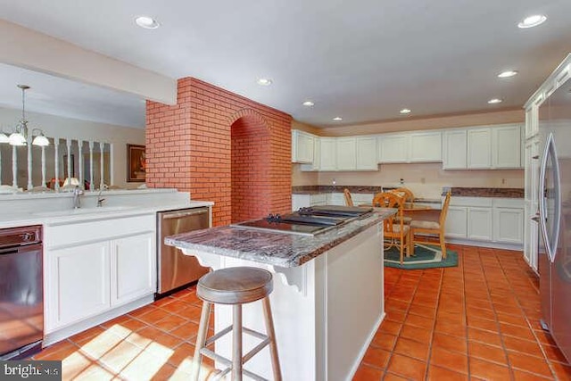 kitchen featuring light tile patterned floors, white cabinetry, and dishwasher