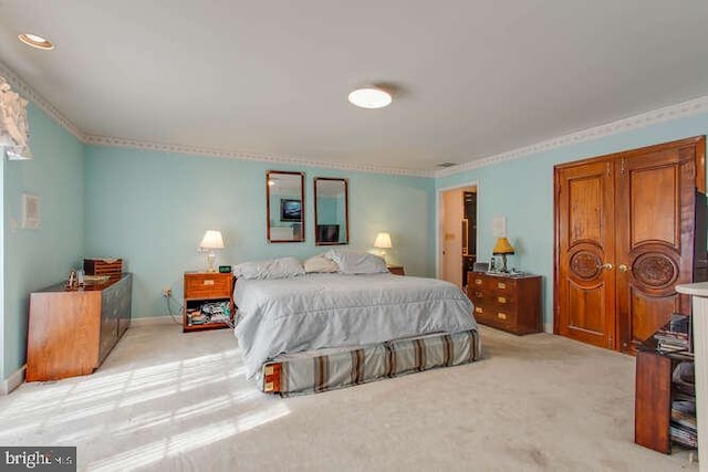 bedroom with light carpet and baseboards