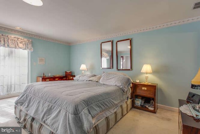 bedroom with light carpet, visible vents, and baseboards