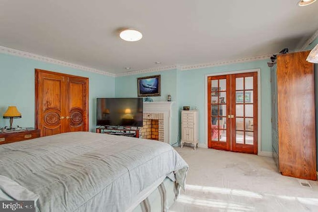 bedroom with french doors, light colored carpet, and baseboards