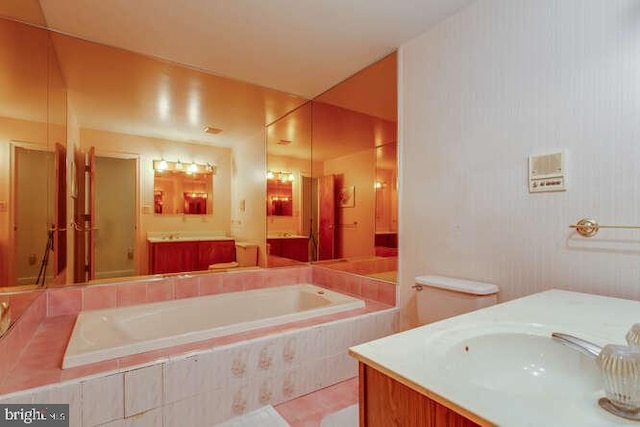 bathroom featuring a garden tub and vanity