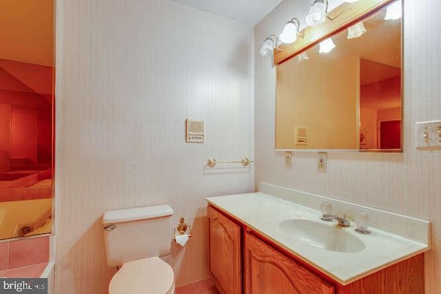 bathroom featuring toilet and vanity