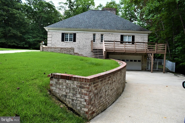 view of front of house featuring a deck, concrete driveway, stairway, a chimney, and a front yard