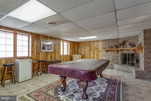 game room with visible vents, a brick fireplace, pool table, and wooden walls