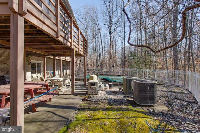 view of yard featuring fence, central AC, and a patio