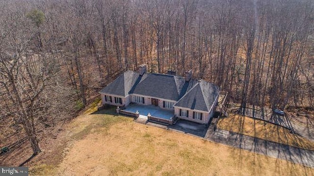 drone / aerial view featuring a wooded view