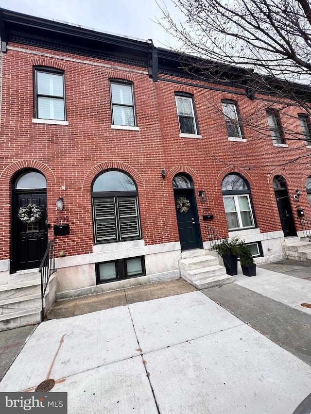 townhome / multi-family property with brick siding