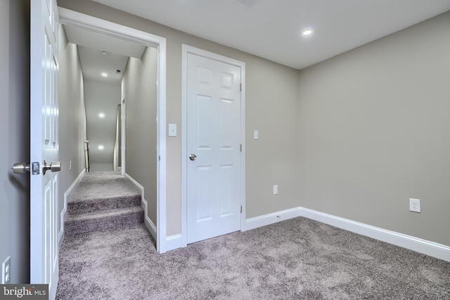 corridor with carpet and baseboards