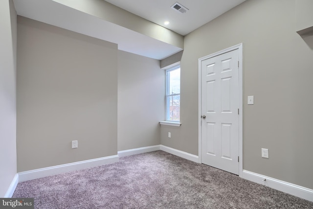 unfurnished room with carpet floors, baseboards, and visible vents