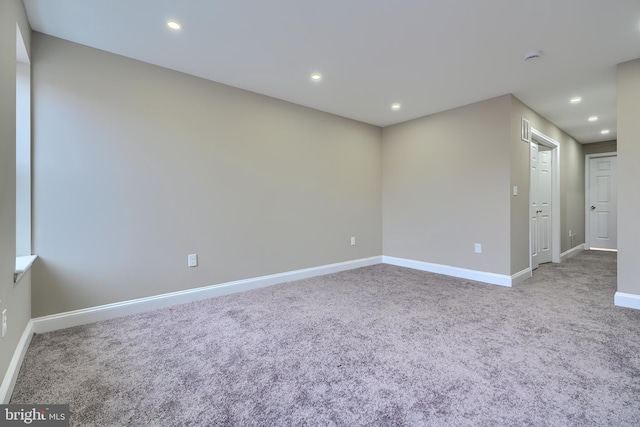 carpeted empty room featuring baseboards and recessed lighting