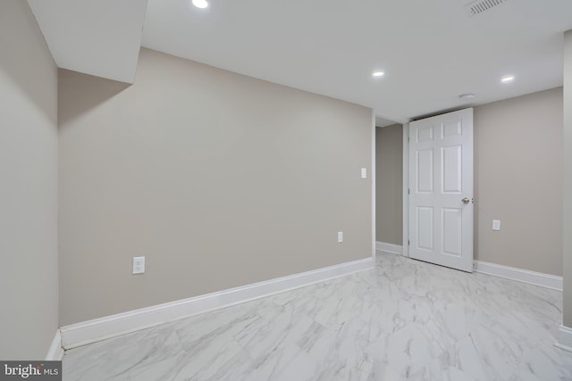 empty room featuring recessed lighting, marble finish floor, visible vents, and baseboards