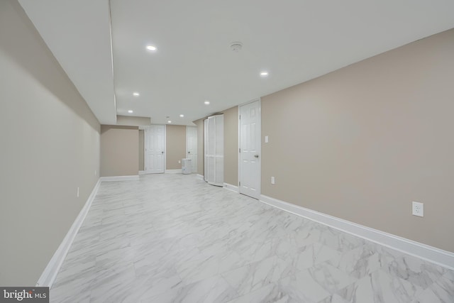 unfurnished room featuring marble finish floor, recessed lighting, and baseboards