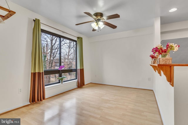 unfurnished room featuring a ceiling fan, baseboards, wood finished floors, and recessed lighting