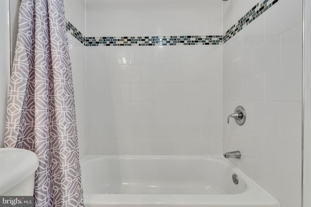 full bathroom with toilet and shower / tub combo with curtain