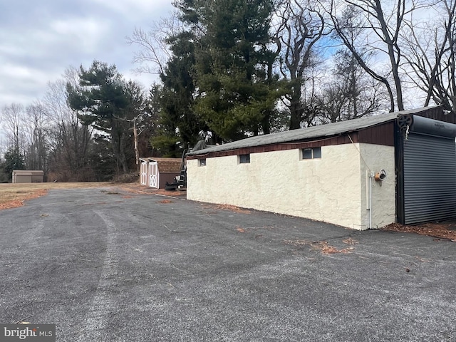 view of property exterior featuring an outdoor structure and stucco siding