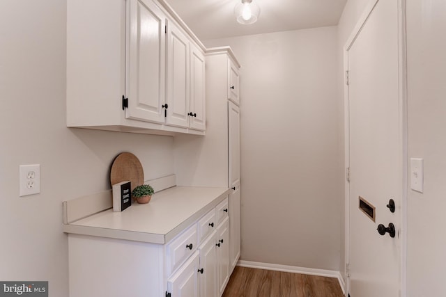 interior space with wood finished floors and baseboards