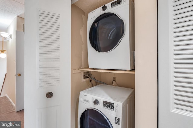 washroom featuring stacked washer and dryer, carpet flooring, and laundry area