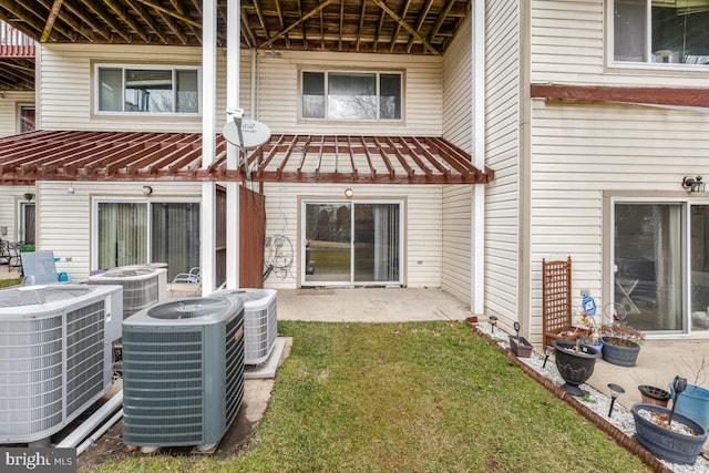 rear view of house featuring central AC and a patio area