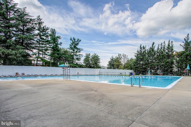 pool featuring a patio area and fence