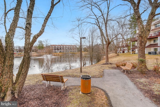 view of yard featuring a water view and central AC unit