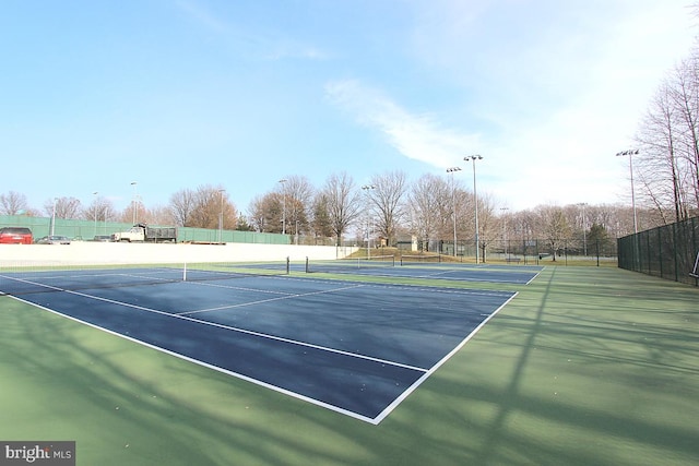 view of sport court featuring fence