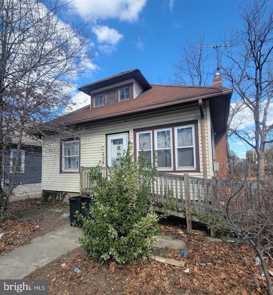 bungalow-style home with a chimney