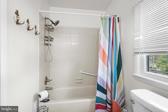 bathroom featuring toilet and shower / bath combo with shower curtain