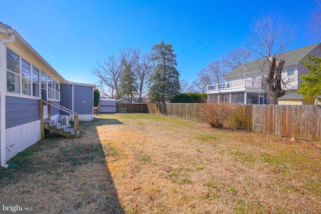 view of yard featuring entry steps and fence