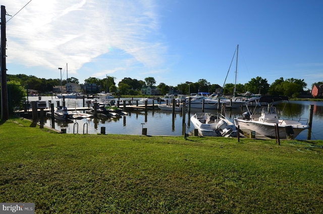 view of dock with a water view and a yard