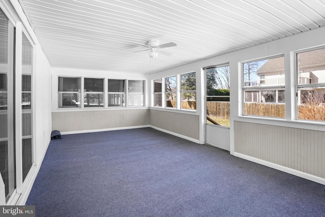 unfurnished sunroom with a ceiling fan