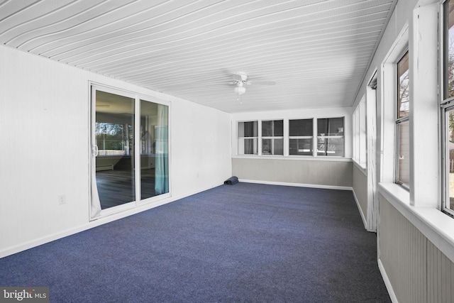 unfurnished sunroom with ceiling fan and baseboard heating