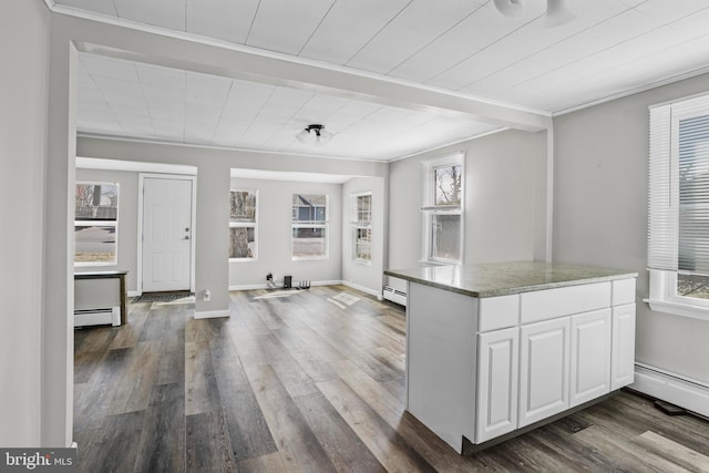 kitchen featuring a baseboard heating unit, white cabinetry, dark wood finished floors, and light stone countertops