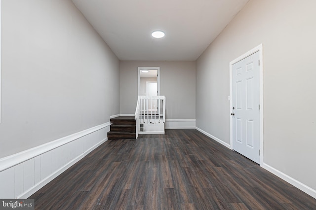 empty room featuring dark wood finished floors and baseboards