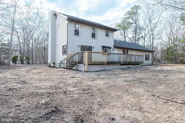 rear view of property with a wooden deck