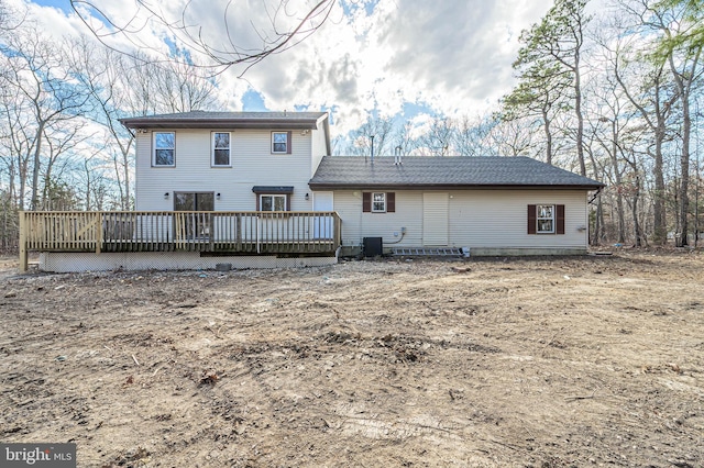 rear view of house with cooling unit and a wooden deck