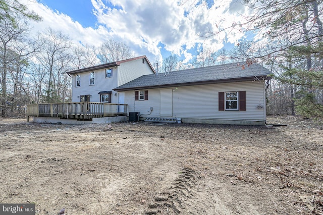 rear view of property with central AC and a wooden deck