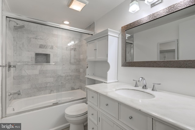 bathroom featuring shower / bath combination with glass door, vanity, and toilet