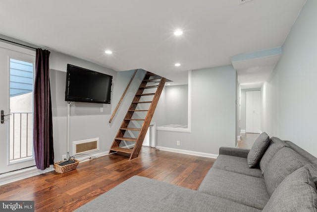 living room featuring wood-type flooring, recessed lighting, baseboards, stairway, and plenty of natural light