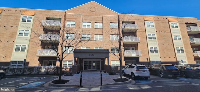 view of building exterior with uncovered parking