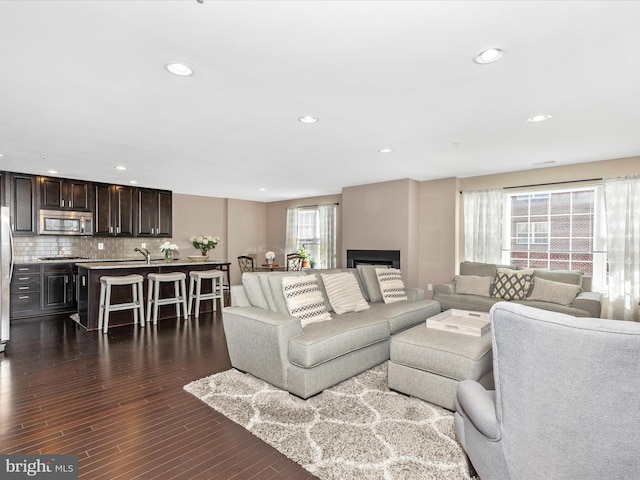 living area with dark wood finished floors and recessed lighting